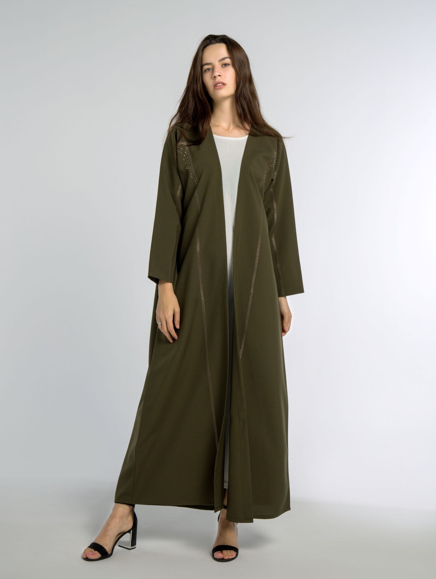 Green abaya for women with geometric patterned embroidery in Dubai online.