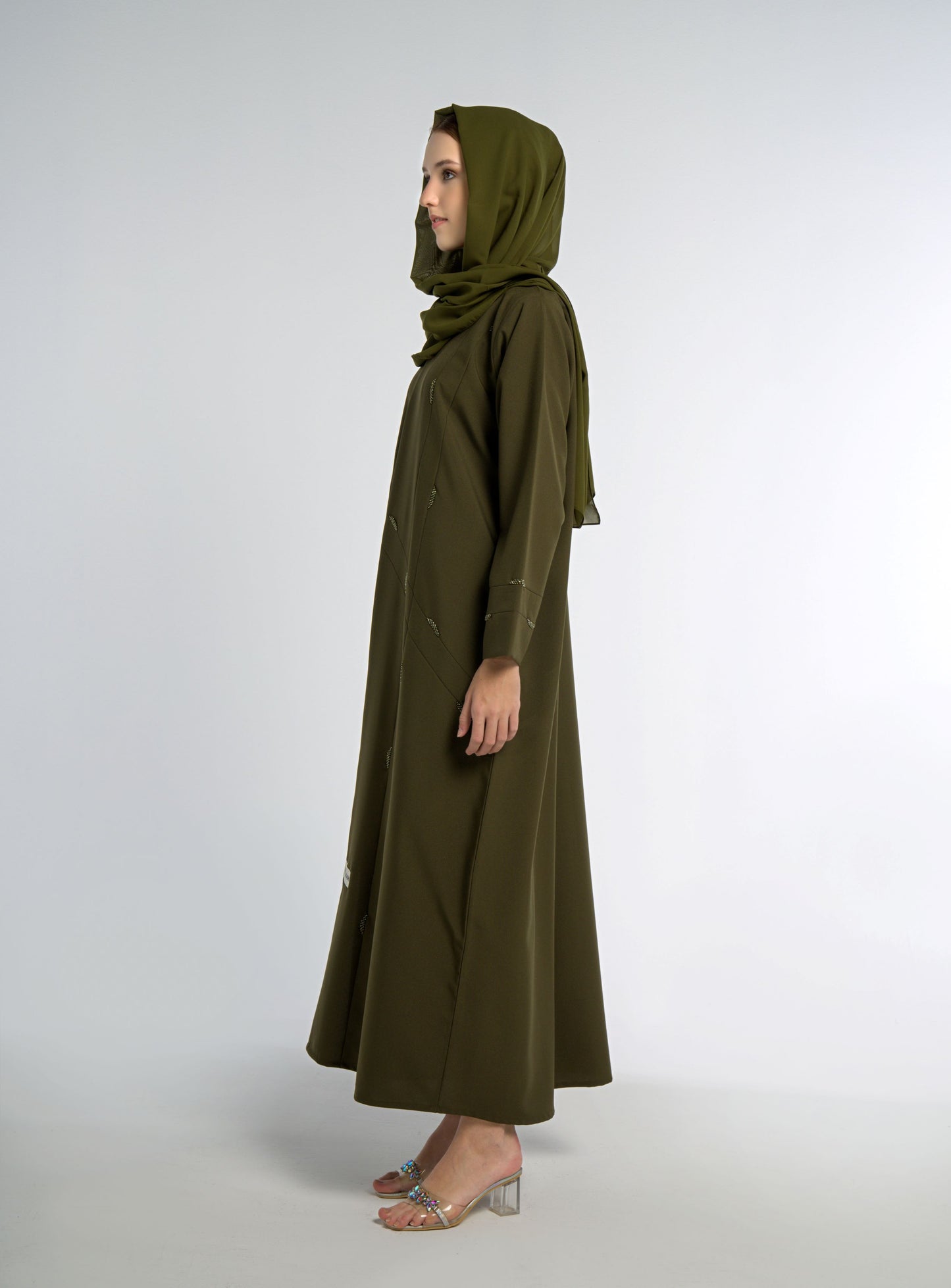Side view of green abaya with line-patterned beaded embellishments
