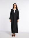 Black bisht abaya with geometrical patterned embroidery.