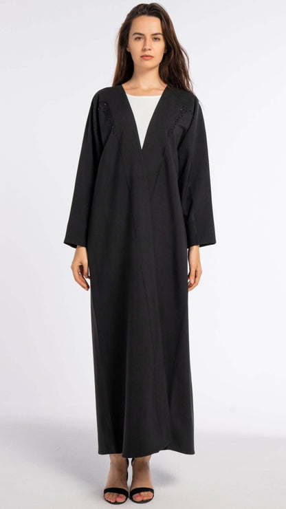 Black bisht abaya with geometrical patterned embroidery.