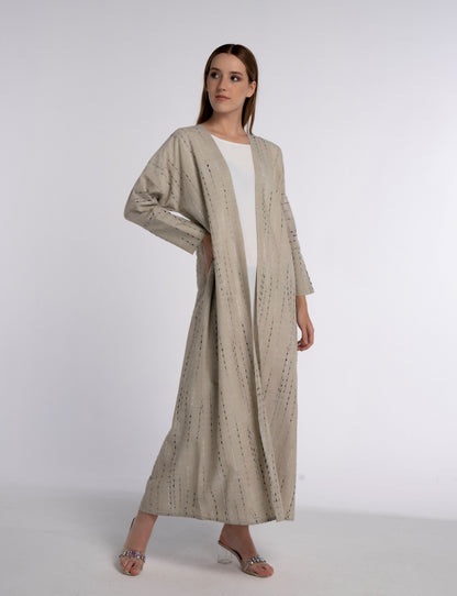 Girl wearing beige abaya for women.