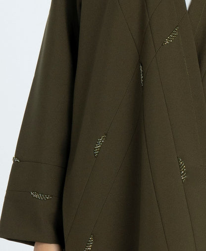 Worm bead embellishments on green bisht abaya.