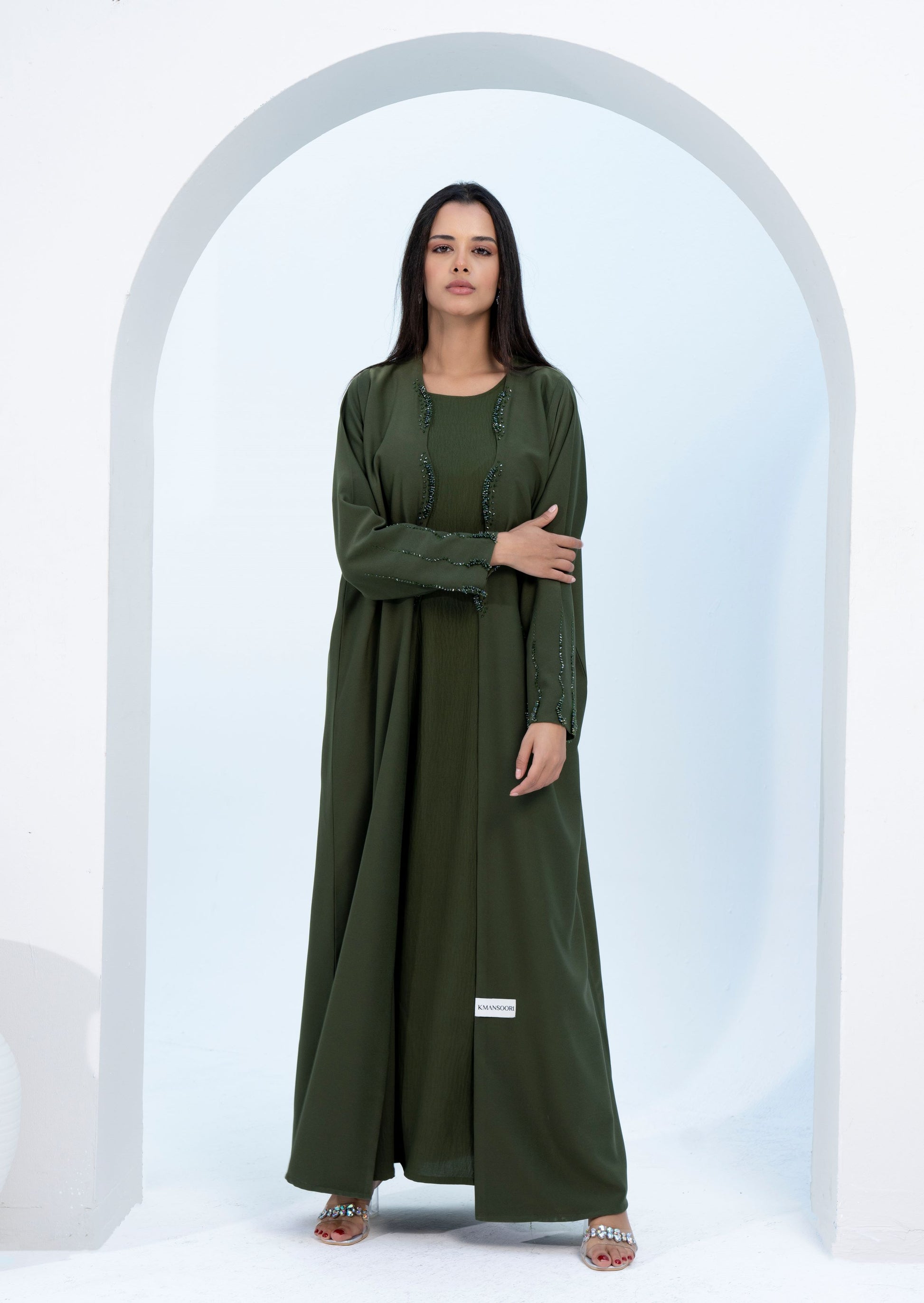 Green bisht abaya with curve cut embellishments on flap and sleeves.