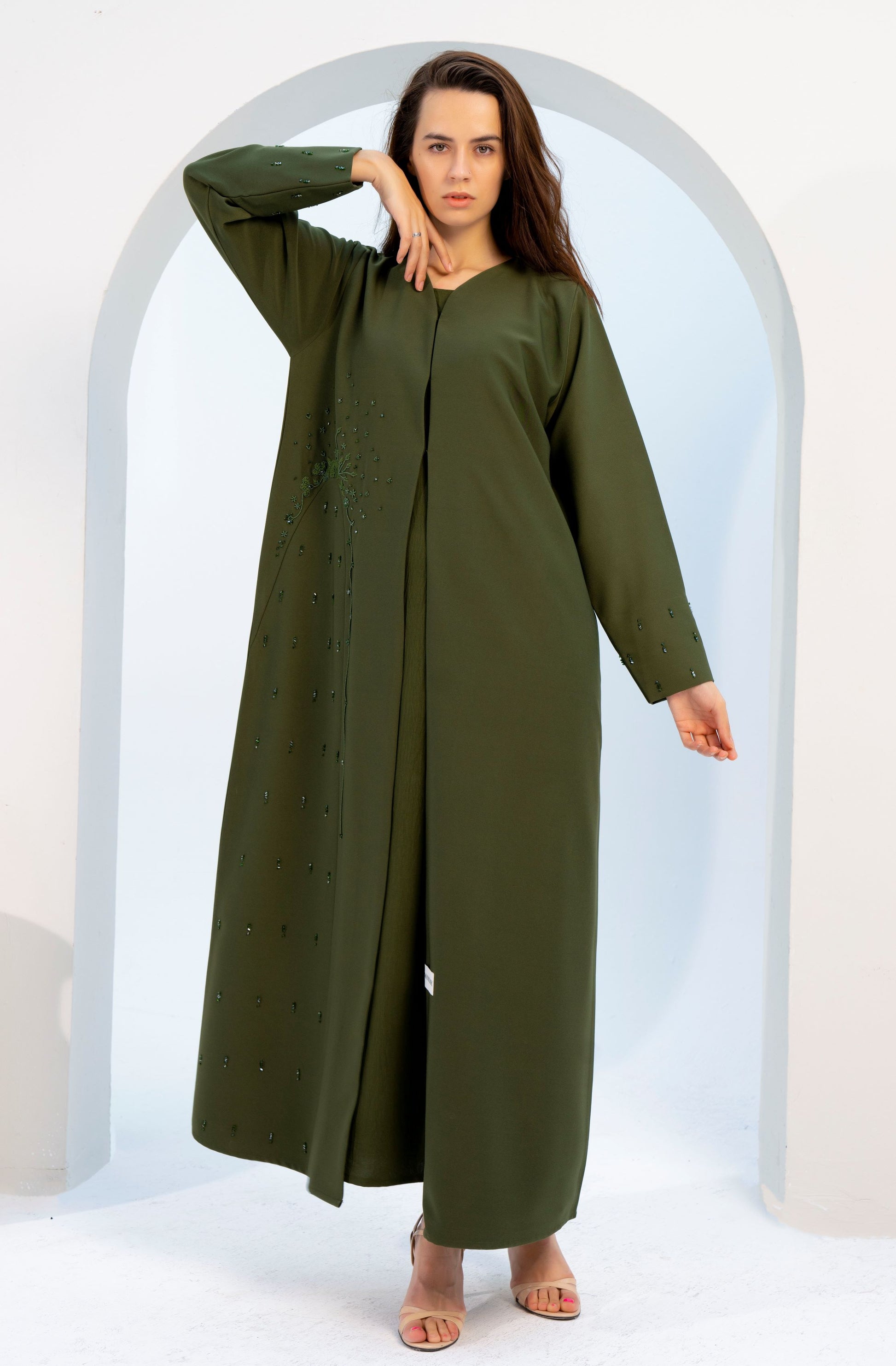 girl wearing green colored V-neck abaya with embellishments