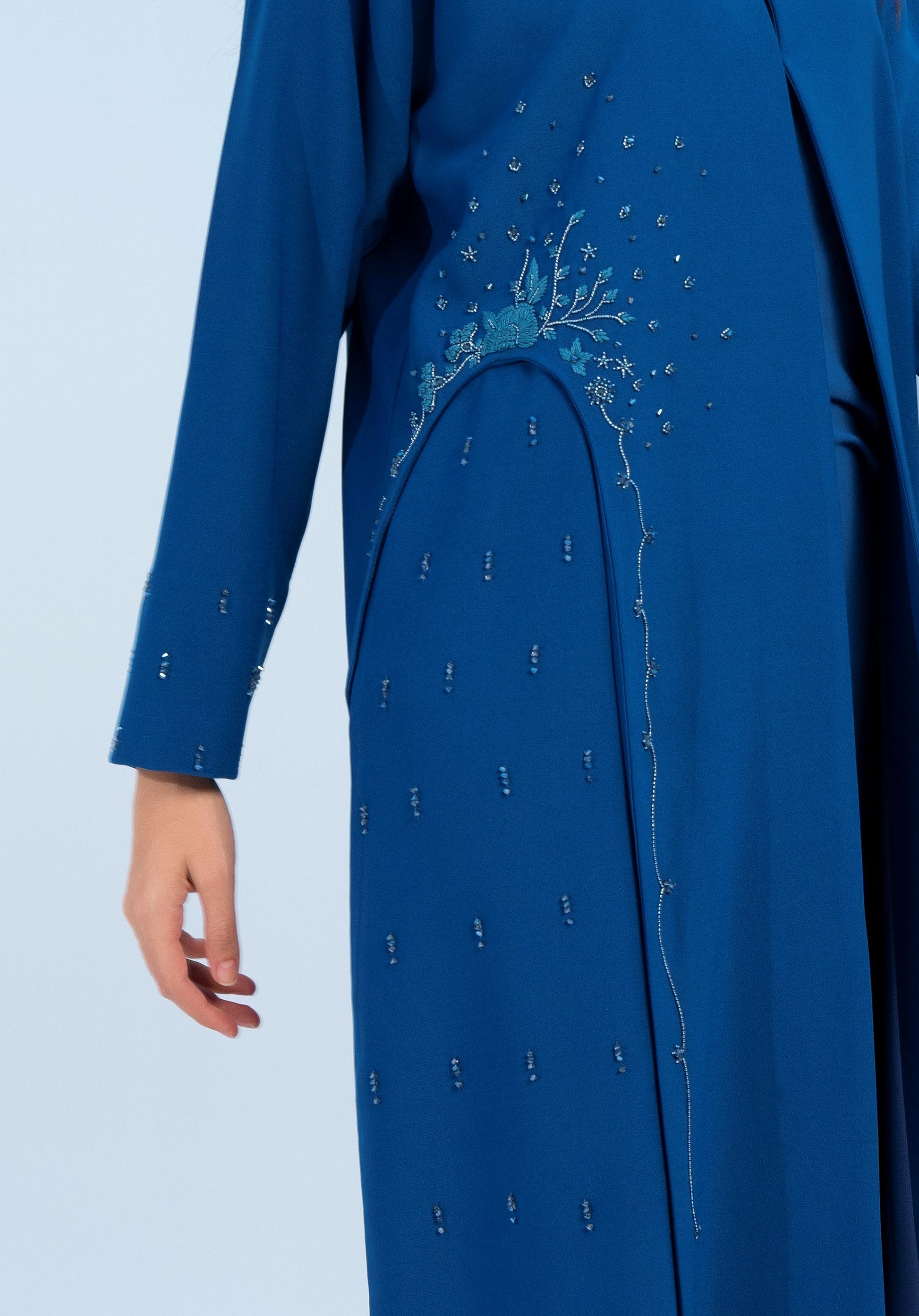 Side view of embellishments on sky blue abaya.