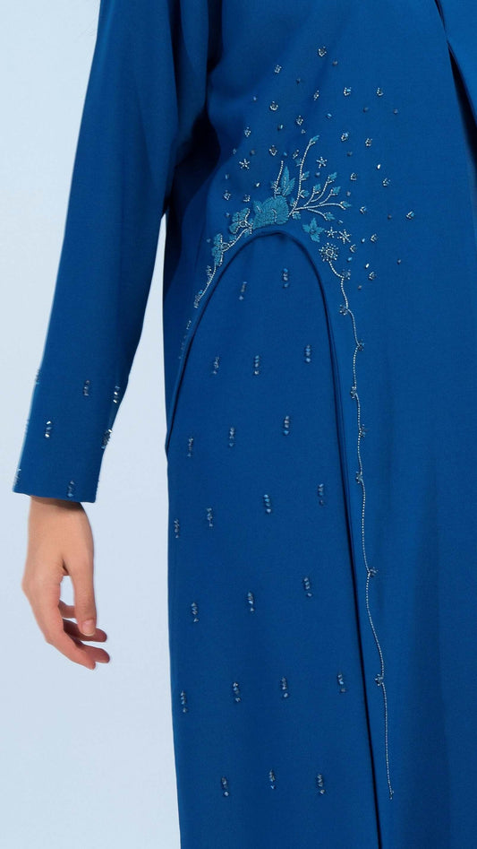 Side view of embellishments on sky blue abaya.