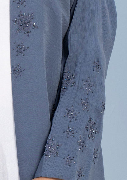 Snowflake embroidery and embellishments on top front flap and sleeves