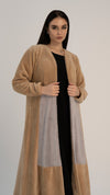 Girl wearing brown woolen abaya with color block pattern.